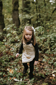 Young Girl Playing in Woods