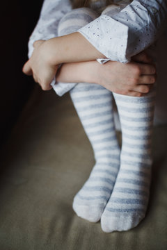 Legs of a little girl in knitted tights