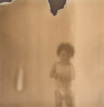 Old Expired Polaroid photo of a kid
