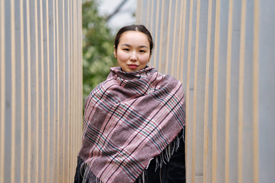 young asian girl in a plaid shawl