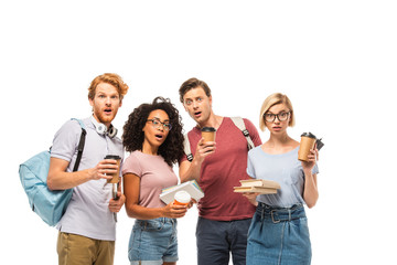 Obraz premium Shocked multicultural students with coffee to go and books looking at camera isolated on white