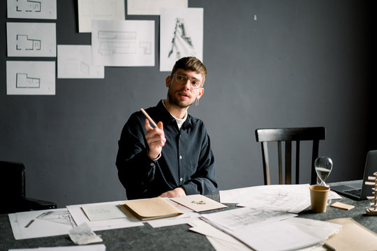 Thoughtful designer drawing sketches