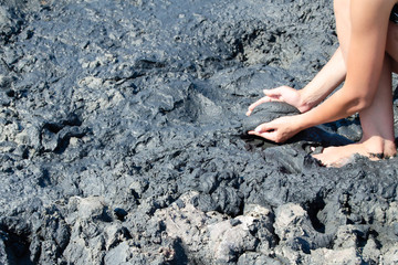 close up of woman applying therapeutic mud