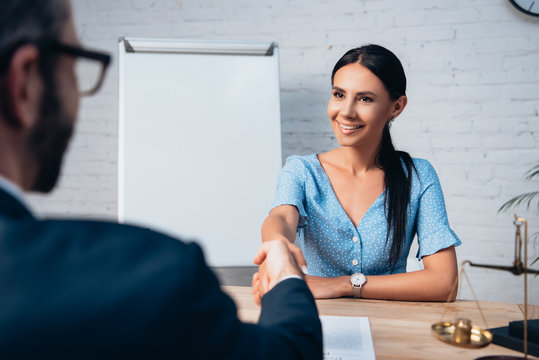 Selective Focus Of Brunette Client Shaking Hands With Lawyer In Office