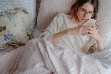 Woman Using Phone After Waking Up