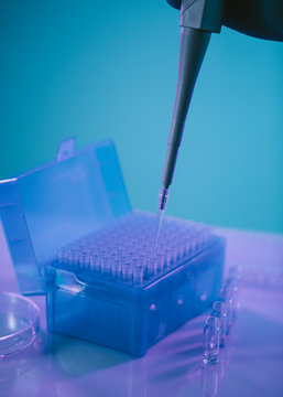Biologist Hand Working with Blue Test Tubes