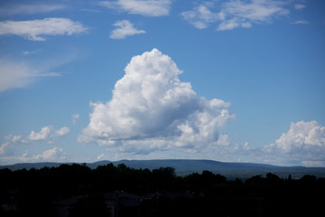 Large white, puffy clouds in sky during the day