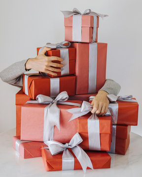 Hands holding a mountain of Christmas gifts. Christmas concept.