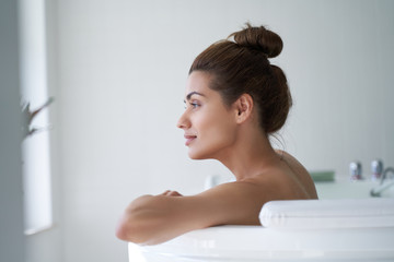 Beautiful woman relaxing in the water and looking away