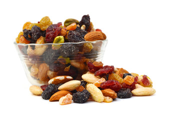 Mix nuts, dry fruits and grapes in glass bowl on a white background