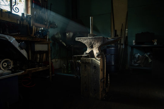 Anvil and hammer in blacksmith workshop.