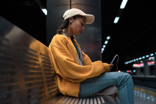 Teenager with earphones at the station