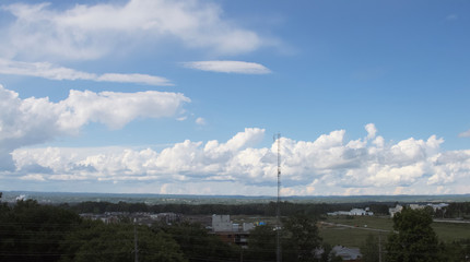 Large white, puffy clouds in sky during the day
