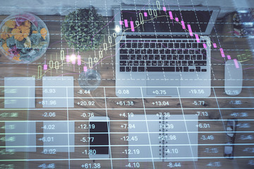 Stock market graph and top view computer on the table background. Multi exposure. Concept of financial education.