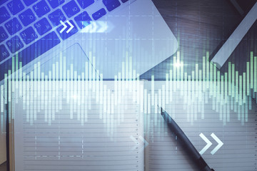 Stock market graph and top view computer on the table background. Multi exposure. Concept of financial education.