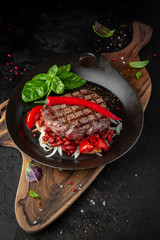 Juicy delicious Mexican beef tenderloin steak with red beans and hot peppers. Hearty meat dish
