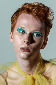 Androgynous man in transparent blouse