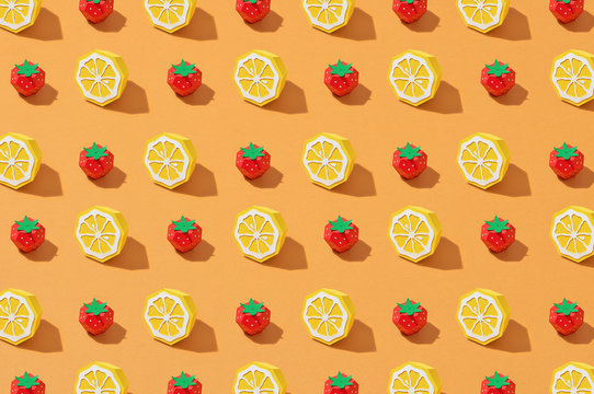 Colorful background with paper lemons and strawberry.