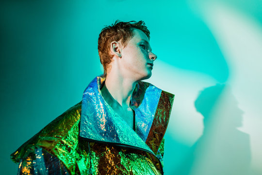 Androgynous man in futuristic jacket