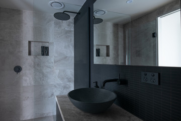 Luxury bathroom with marble tiles and wenge cabinetry