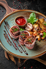 Fillet mignon baked in bacon and cheese with fried potatoes and herbs.