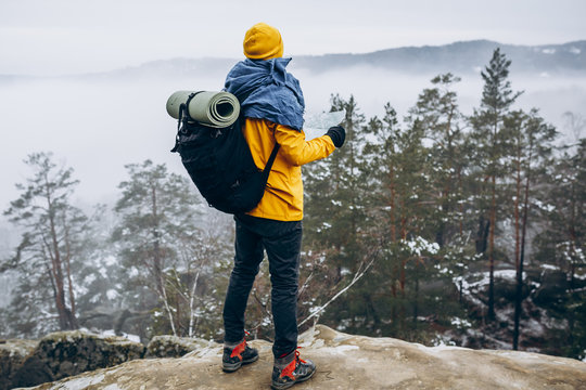 Climber hiking to top of mountain and feeling happy.