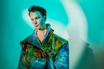 Androgynous man in futuristic jacket