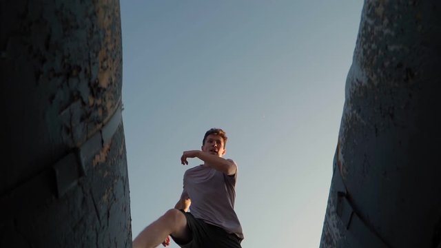 Playful Happy man runs and jumps in the sunlight. Freedom and happiness. Bottom view. Slow motion