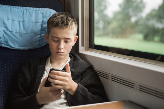 Teenager using phone on the train
