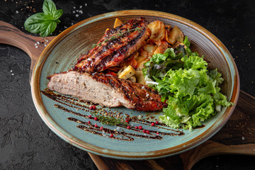 Beef or pork tenderloin steak with fried potatoes. Grilled meat. A balanced tasty meal.