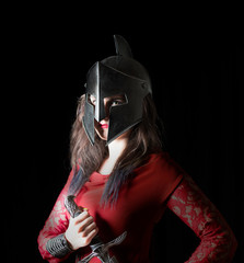 woman with sword gauntlets and roman helmet