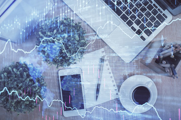 Multi exposure of financial chart hologram over desktop with phone. Top view. Mobile trade platform concept.