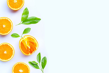 Orange fruit with leaves on white background.