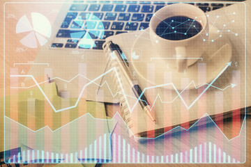 Double exposure of forex chart drawing and desktop with coffee and items on table background. Concept of financial market trading