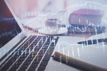Double exposure of financial chart drawing and desktop with coffee and items on table background. Concept of forex market trading