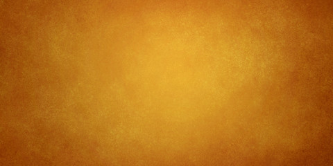 orange golden brown abstract grunge background with light in the center and darkening at the edges
