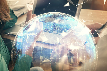 Double exposure of man and woman working together and financial theme hologram. international business concept. Computer background.