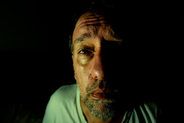 Middle-aged man with a long beard. Expression of depression or anxiety. Concept of psychological...