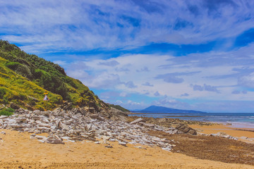 ocean shore with boulders, sand