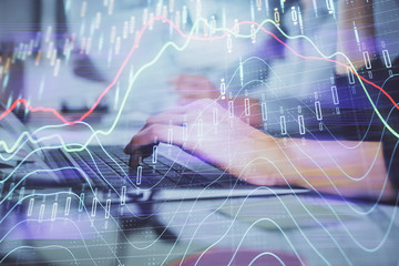 Naklejka premium Multi exposure of woman hands typing on computer and financial graph hologram drawing. Stock market analysis concept.