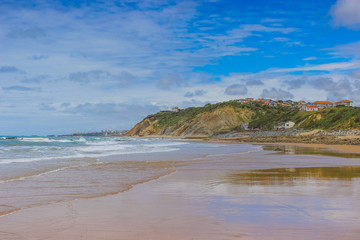 Turquoise sea with tropical beach. Coastline of the ocean, rocks and sand. Sea line from France on the beach. Leisure activities in heavenly resorts, travel concept, lifestyle.