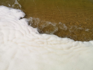 Yellow Sand beach and transparent wave closeup