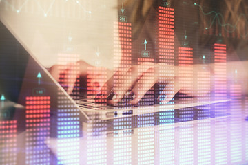 Double exposure of woman hands typing on computer and forex chart hologram drawing. Stock market invest concept.