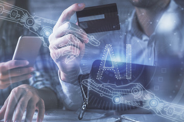 Double exposure of man and woman on-line shopping holding a credit card and data theme hologram drawing. Ai and E-commerce pay on-line concept.