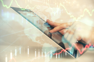 Multi exposure of man's hands holding and using a digital phone and forex graph drawing. Financial market concept.