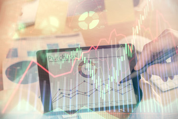 Fototapeta premium Double exposure of man's hands holding and using a phone and financial chart drawing. Market analysis concept.
