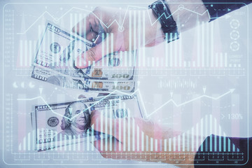 Multi exposure of financial graph drawing hologram and USA dollars bills and man hands. Analysis concept.