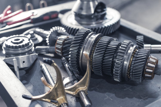 parts of an automotive manual transmission on a table in a car service. Close up