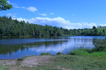 Tranquil lake surrounded by forest and hills