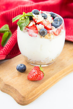 Healthy blueberry, strawberry and walnut parfait in a glass 